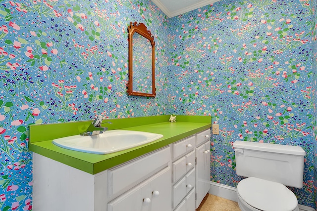 bathroom with tile patterned flooring, vanity, toilet, and crown molding