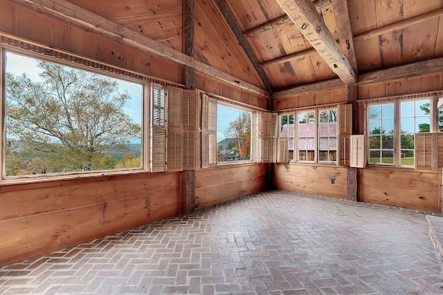 unfurnished sunroom featuring vaulted ceiling with beams and wood ceiling