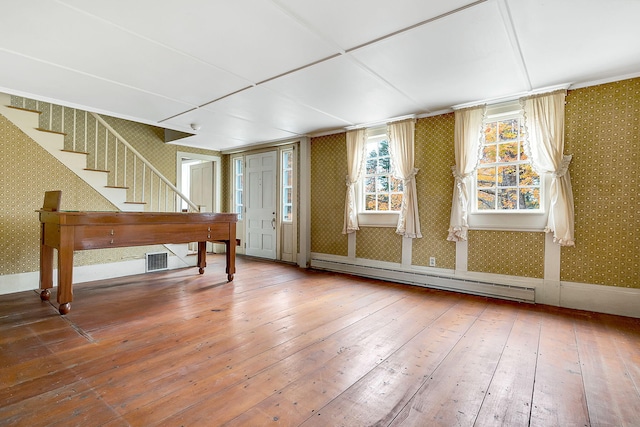 interior space with wood-type flooring and baseboard heating