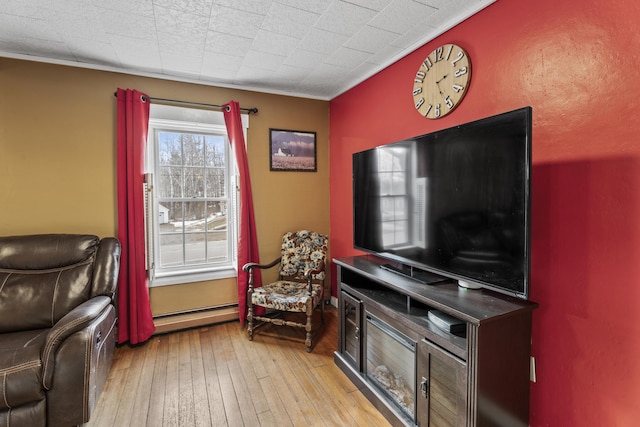 living area with light hardwood / wood-style flooring and a baseboard radiator