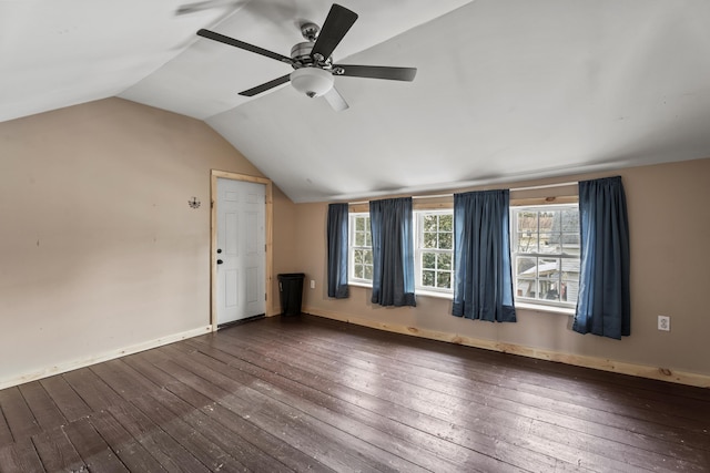 interior space featuring ceiling fan, dark wood-type flooring, and vaulted ceiling