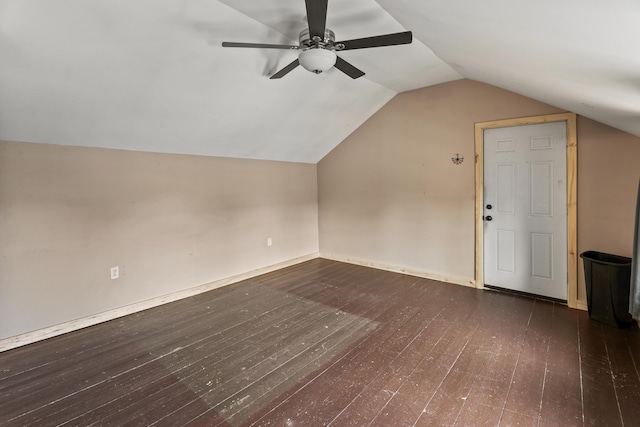 additional living space with dark hardwood / wood-style floors, ceiling fan, and vaulted ceiling