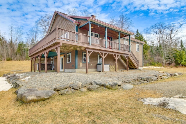 rear view of property with a wooden deck