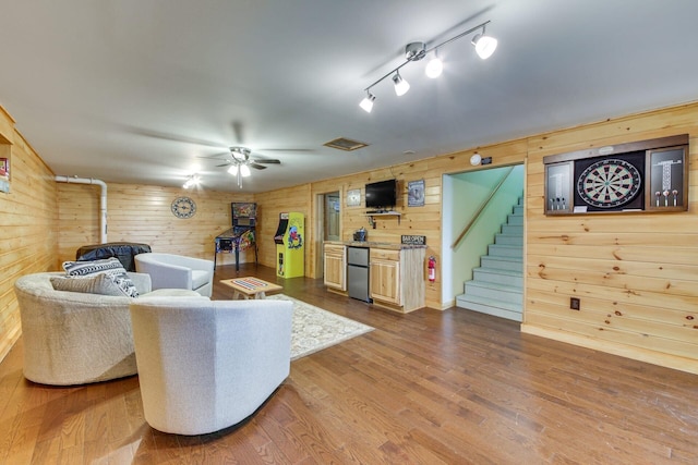 433 Works Rd, Jackson, ME 04921 - living room featuring rail lighting, hardwood / wood-style flooring, ceiling fan, and wooden walls