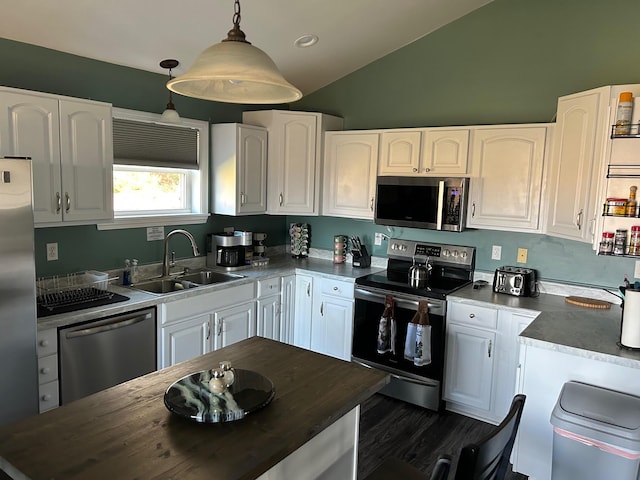 433 Works Rd, Jackson, ME 04921 - kitchen featuring white cabinetry, sink, hanging light fixtures, lofted ceiling, and appliances with stainless steel finishes