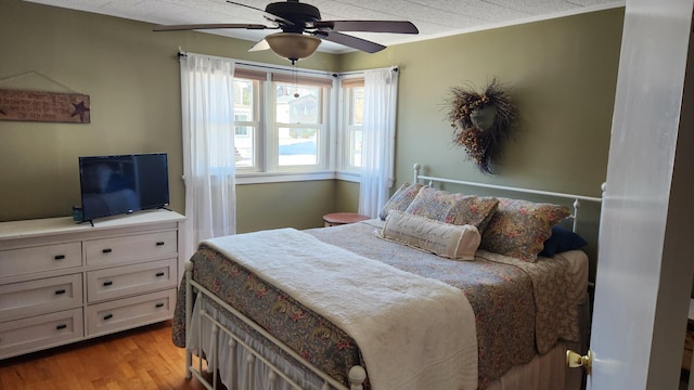 bedroom with light wood finished floors and ceiling fan