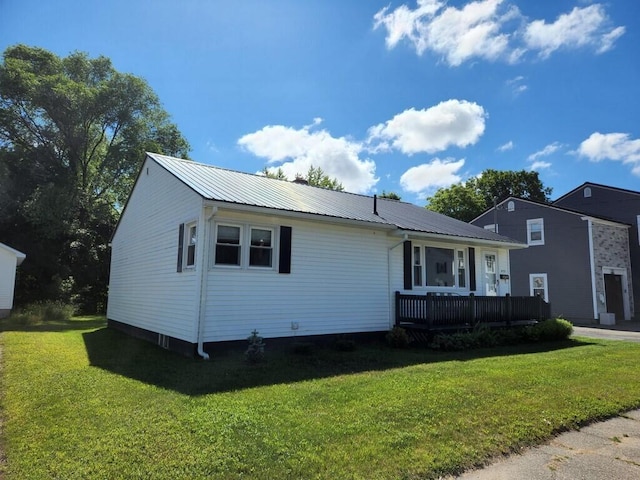 433 Aroostook Ave, Millinocket, ME 04462 - view of front facade featuring metal roof, a front yard, and a wooden deck