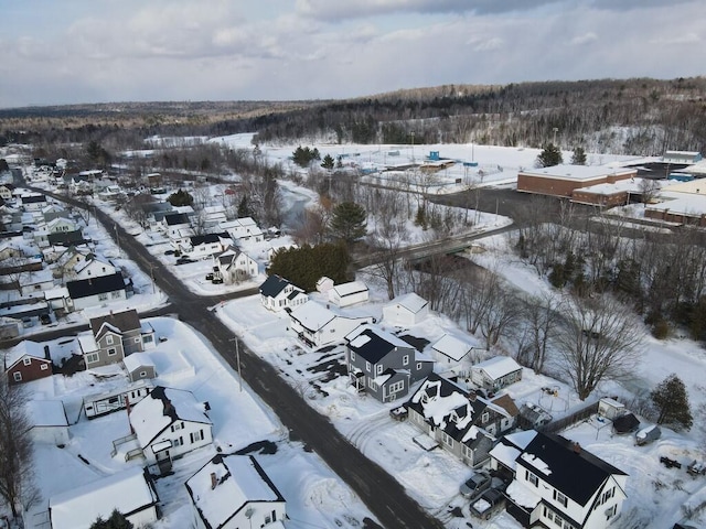 snowy aerial view featuring a residential view