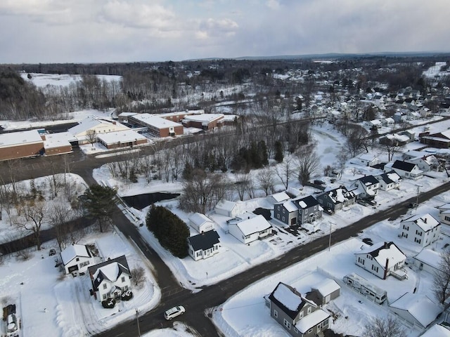 snowy aerial view with a residential view