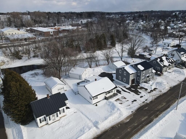 snowy aerial view featuring a residential view