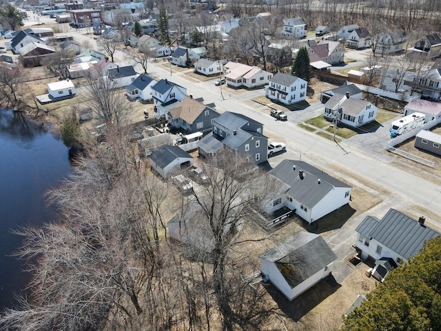 drone / aerial view with a residential view and a water view
