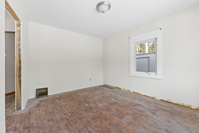 unfurnished room with wood-type flooring