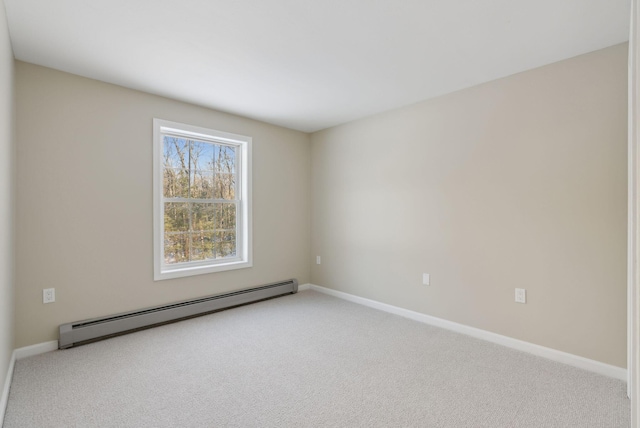 carpeted spare room with a baseboard heating unit