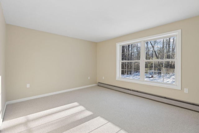 empty room with a baseboard heating unit and carpet