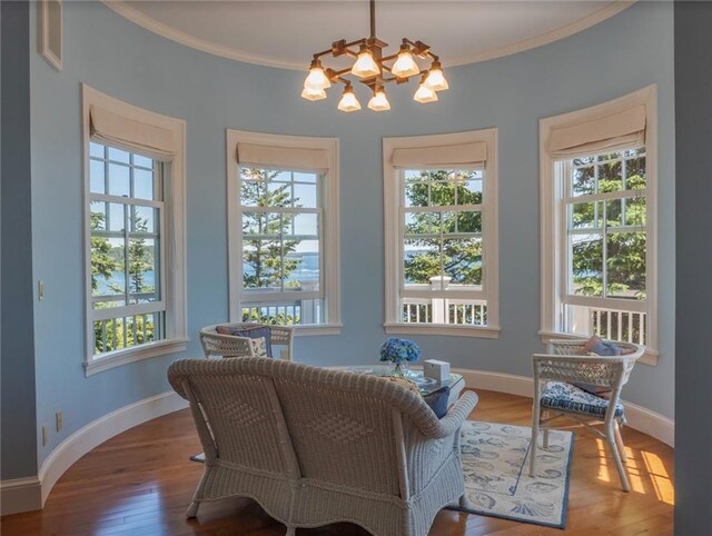 sitting room featuring ornamental molding and a chandelier