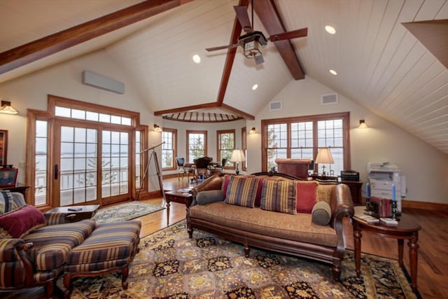 bedroom with multiple windows, hardwood / wood-style floors, lofted ceiling with beams, and a wall mounted air conditioner