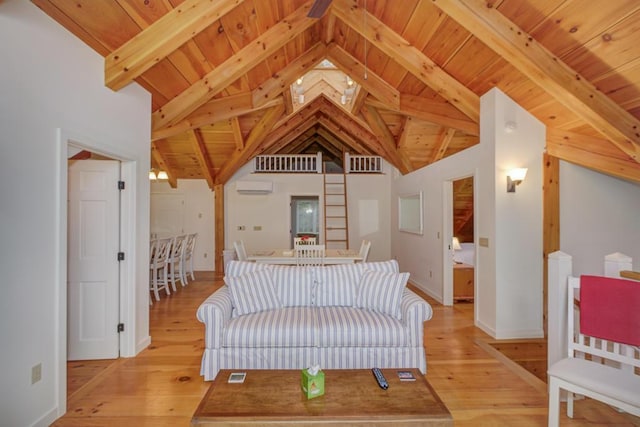 living room featuring a wall mounted air conditioner, beam ceiling, light wood-type flooring, and wood ceiling