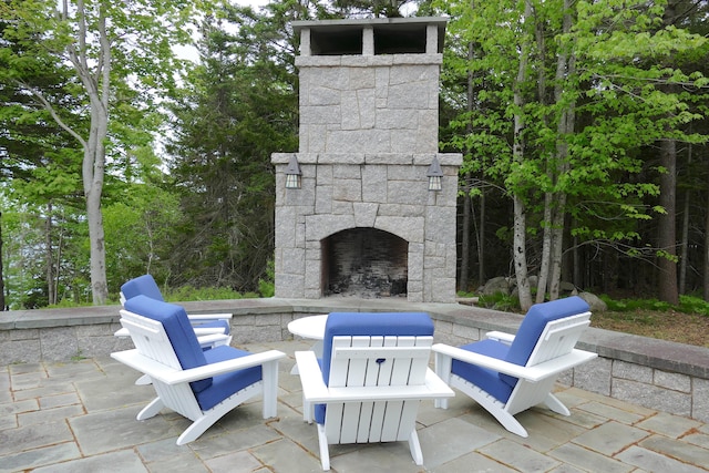 view of patio / terrace with an outdoor stone fireplace