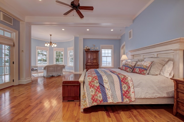 bedroom featuring access to outside, multiple windows, crown molding, and ceiling fan with notable chandelier