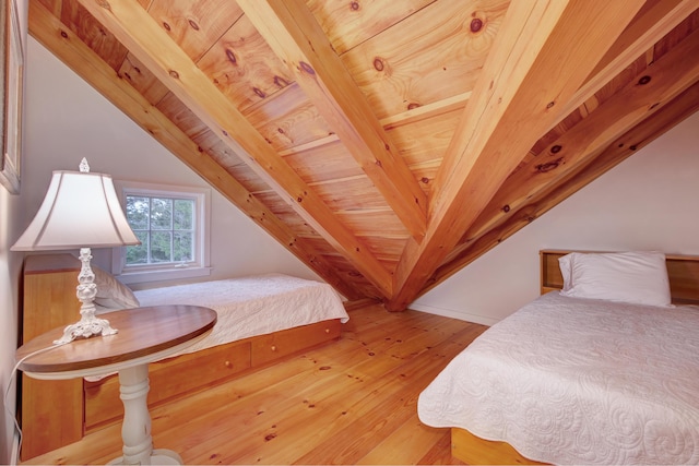 bedroom featuring vaulted ceiling with beams, light hardwood / wood-style flooring, and wood ceiling