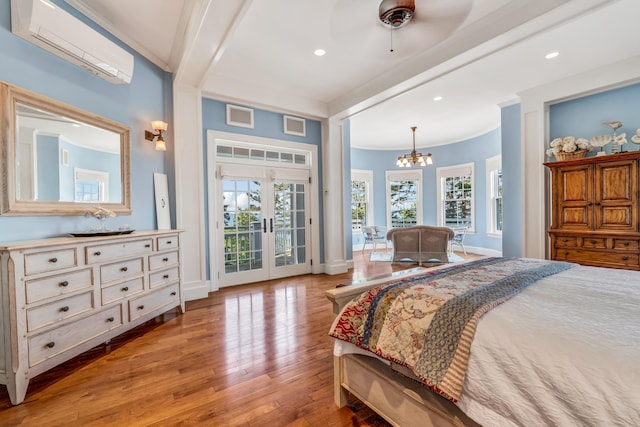62 Sols Cliff Rd, Bar Harbor, ME 04609 - bedroom with access to exterior, a chandelier, a wall unit AC, wood-type flooring, and crown molding