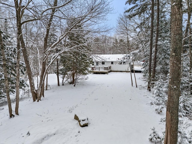 snowy yard with a wooden deck