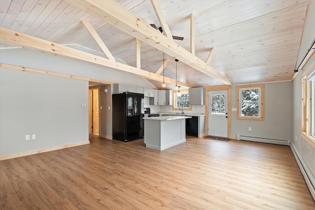 kitchen with hanging light fixtures, tasteful backsplash, lofted ceiling with beams, a kitchen island, and black appliances