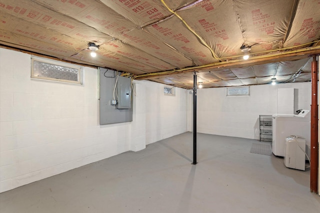 basement featuring electric panel and washing machine and dryer