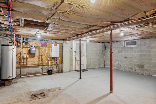 basement featuring gas water heater and tankless water heater