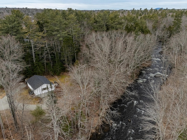 birds eye view of property with a wooded view