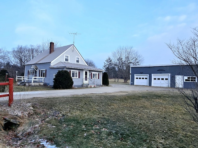 view of property exterior with a lawn, an outbuilding, and a garage