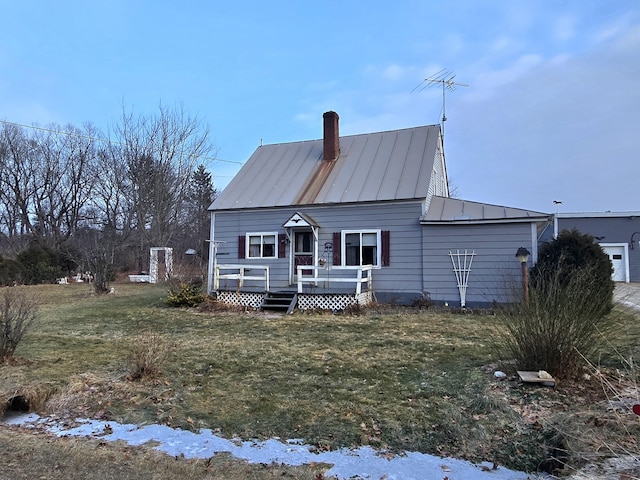 back of house with a lawn