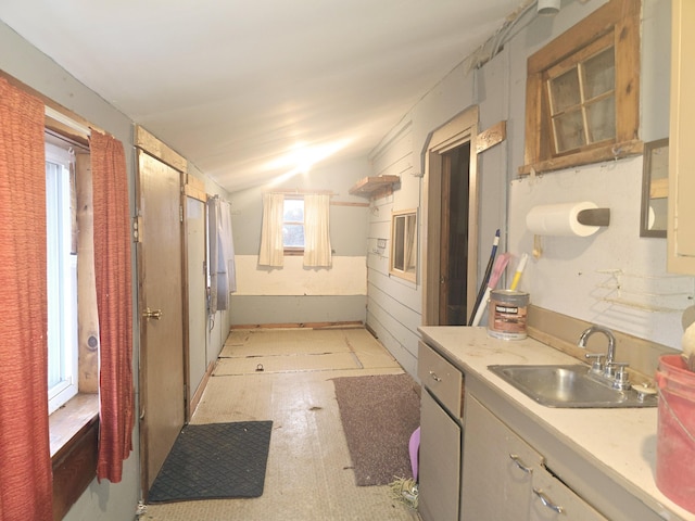 kitchen with lofted ceiling and sink