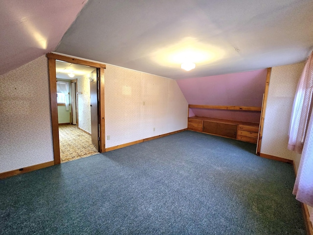 additional living space with carpet and vaulted ceiling