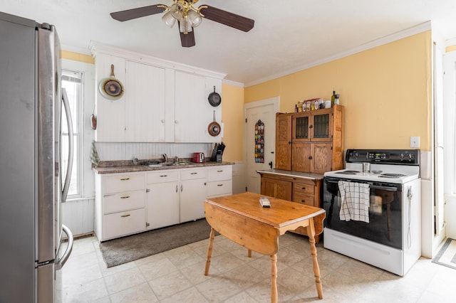 kitchen with stainless steel refrigerator, ceiling fan, white range with electric cooktop, white cabinets, and ornamental molding