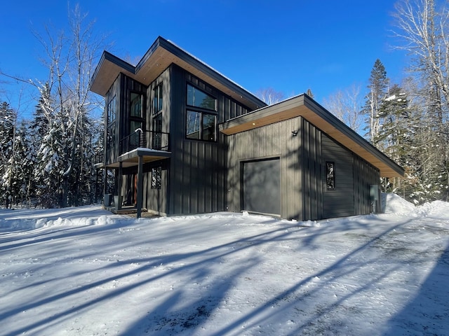 view of snow covered exterior with a balcony