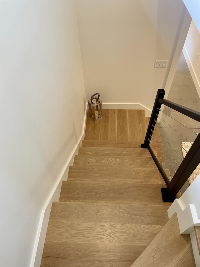 stairway with hardwood / wood-style floors