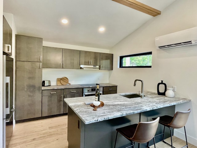 kitchen featuring kitchen peninsula, sink, lofted ceiling with beams, an AC wall unit, and oven