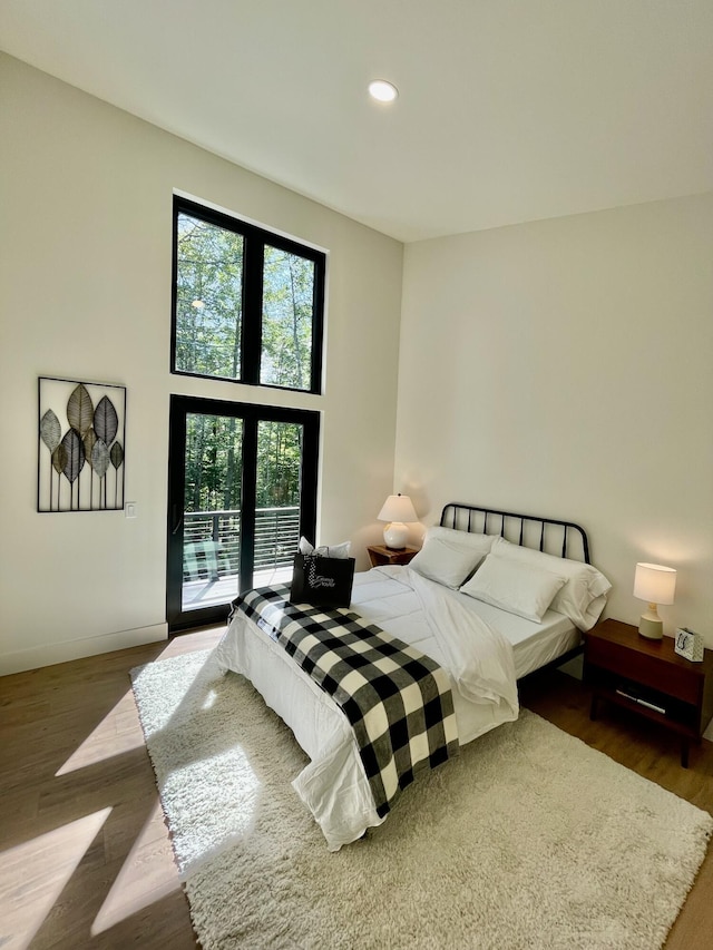 bedroom featuring hardwood / wood-style flooring and access to outside