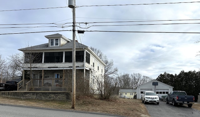 view of front of house with an outbuilding, a porch, and a garage