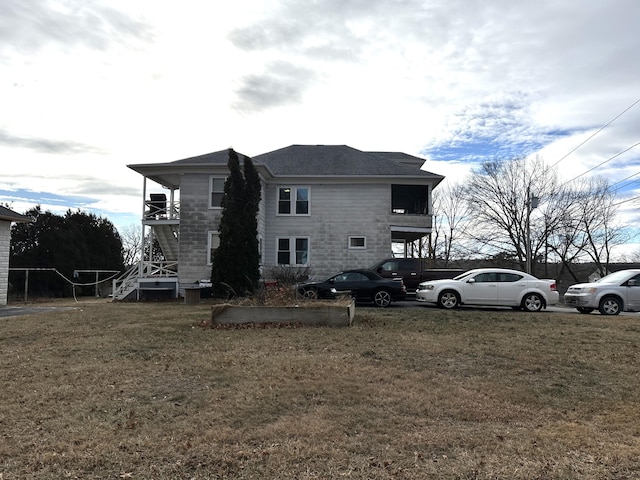 back of property featuring a lawn