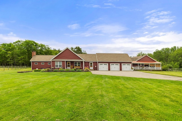 view of front of property with a garage and a front lawn