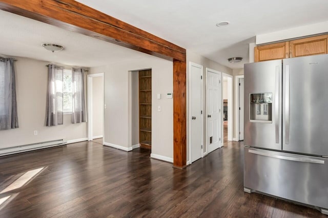 kitchen featuring light brown cabinetry, dark wood-type flooring, a baseboard radiator, and stainless steel fridge