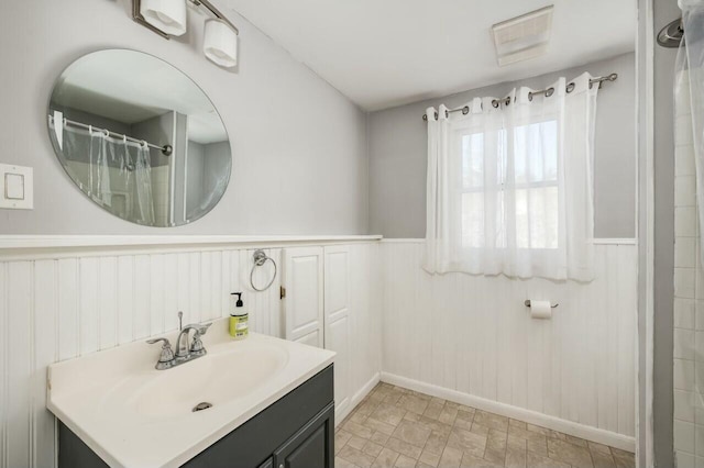 bathroom featuring vanity, wood walls, and curtained shower