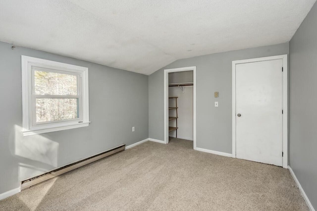 unfurnished bedroom with a baseboard radiator, a textured ceiling, light carpet, and lofted ceiling