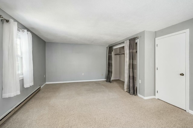 unfurnished bedroom with a baseboard radiator and a textured ceiling