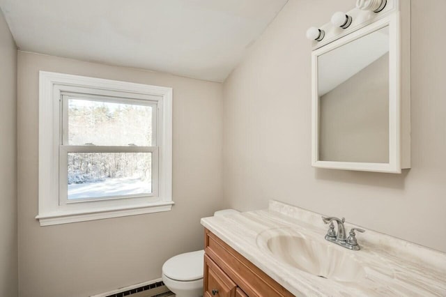 bathroom featuring a baseboard radiator, toilet, and vanity