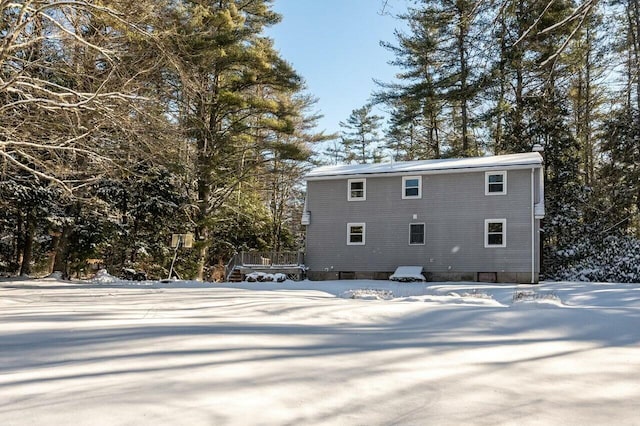 view of snow covered rear of property