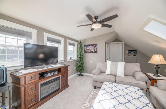 living room featuring ceiling fan, lofted ceiling, and light colored carpet