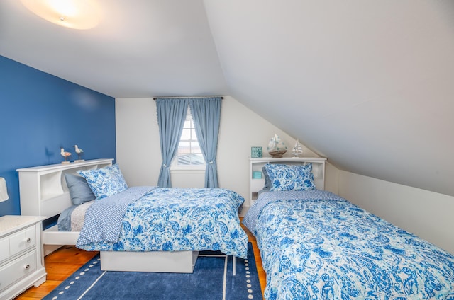 bedroom featuring lofted ceiling and wood-type flooring